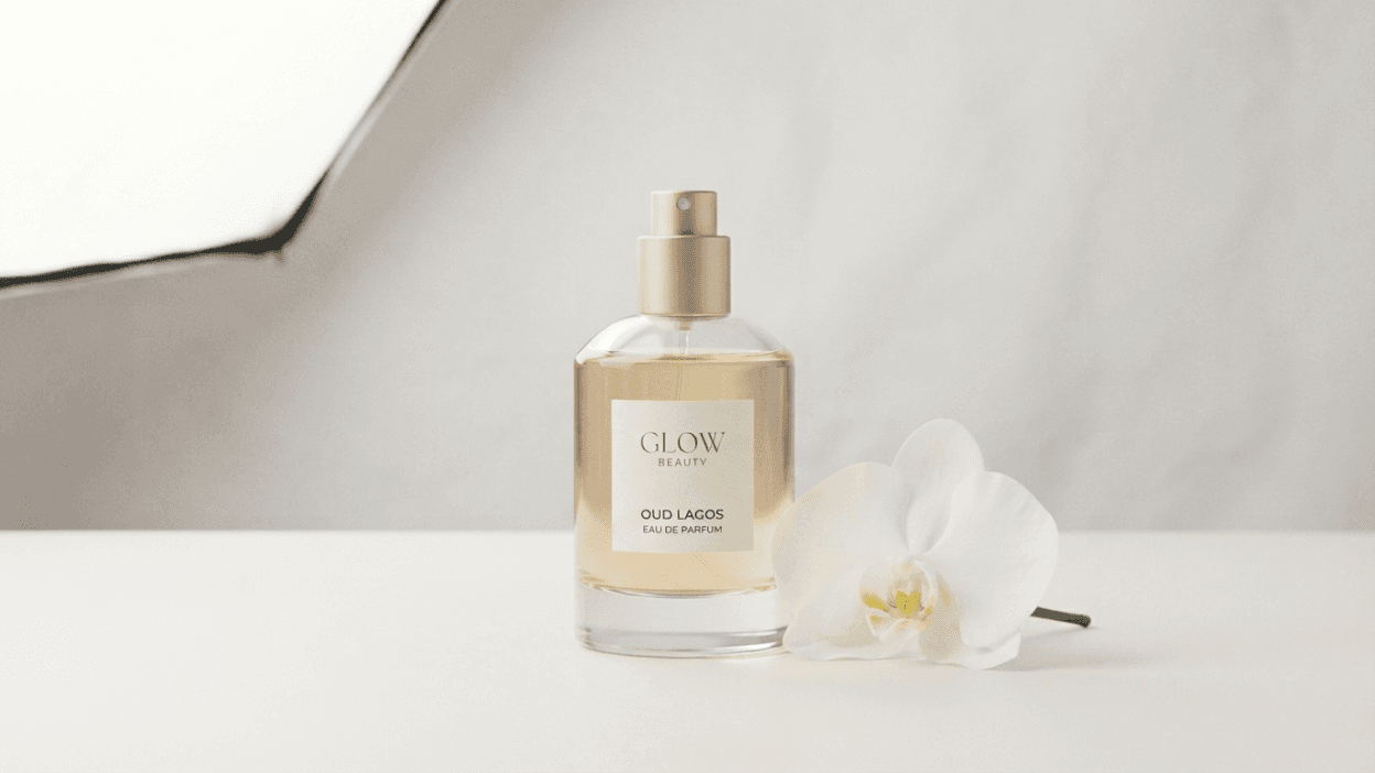 Glow Beauty Oud Lagos Eau de Parfum bottle with white orchid on marble